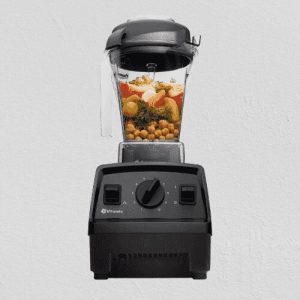"High-speed blender mixing smoothie ingredients in a glass jar"